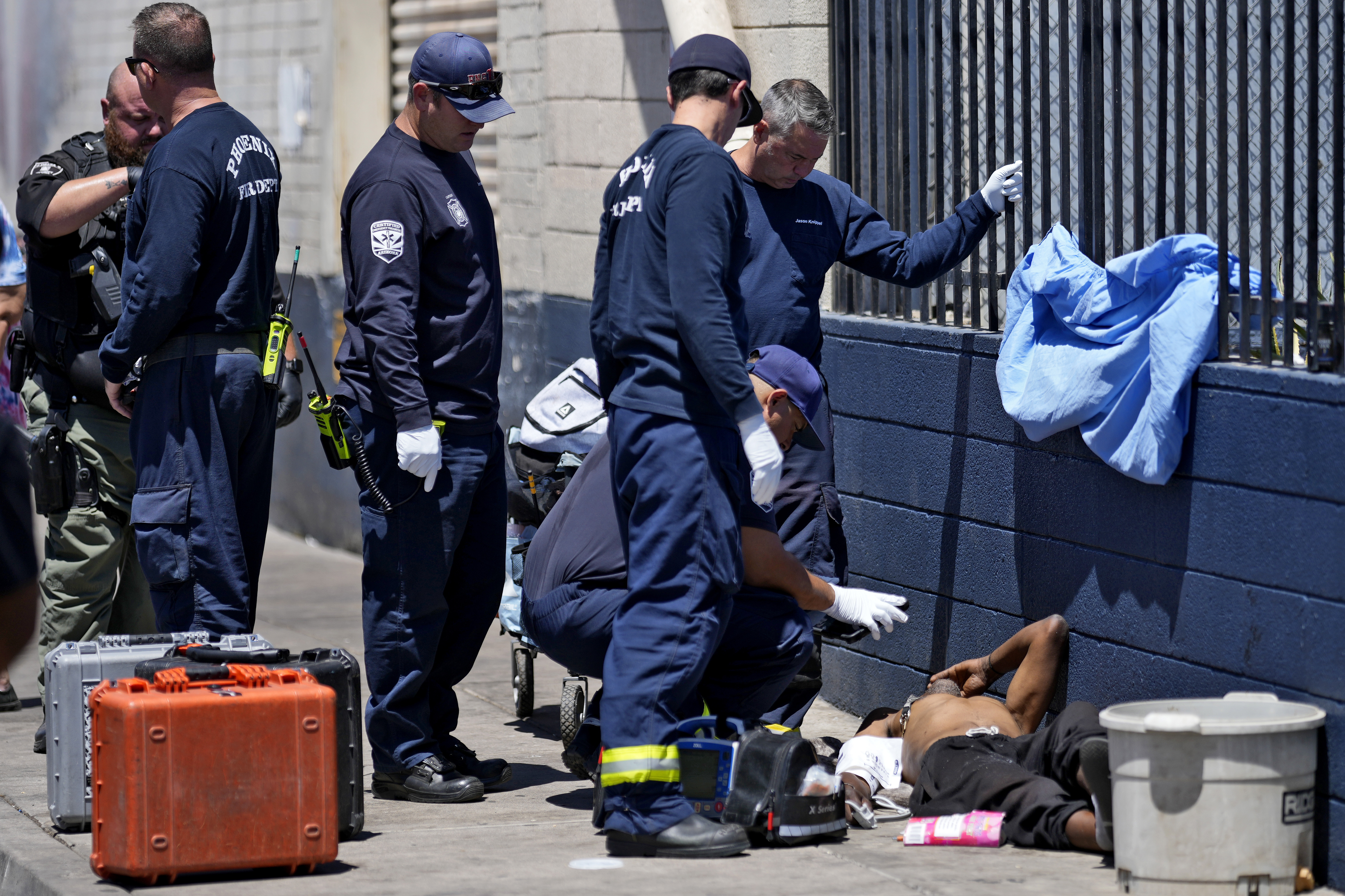 Phoenix firefighters give medical attention to a homeless man, Thursday, May 30, 2024 in Phoenix. Phoenix firefighters give medical attention to a homeless man, Thursday, May 30, 2024 in Phoenix.