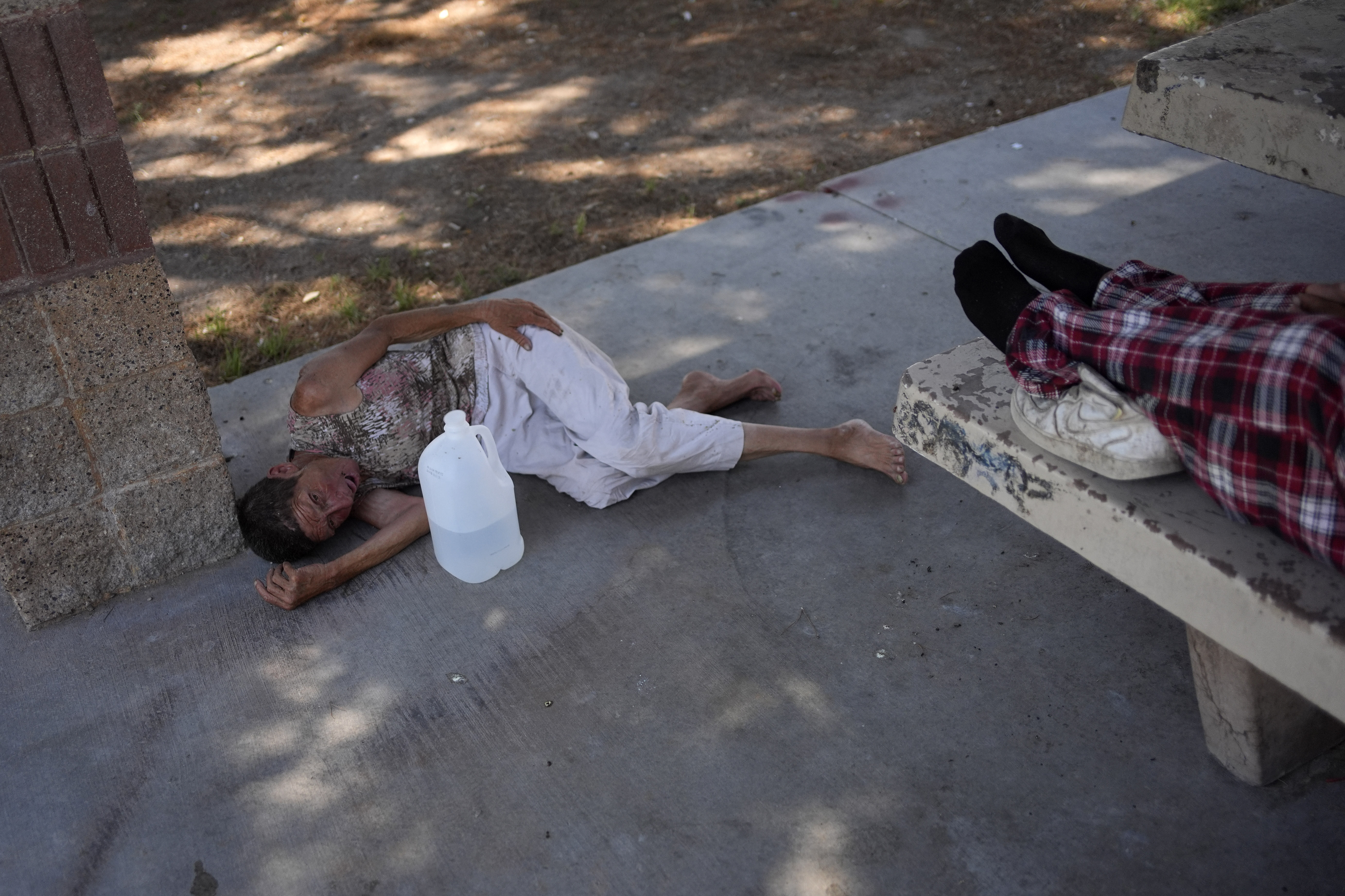 FILE - Deb Billet, 66, lies on the ground while Henderson Public Response officers call an ambulance to take her to the hospital for heat-related symptoms Wednesday, July 10, 2024, in Henderson, Nev. FILE - Deb Billet, 66, lies on the ground while Henderson Public Response officers call an ambulance to take her to the hospital for heat-related symptoms Wednesday, July 10, 2024, in Henderson, Nev.