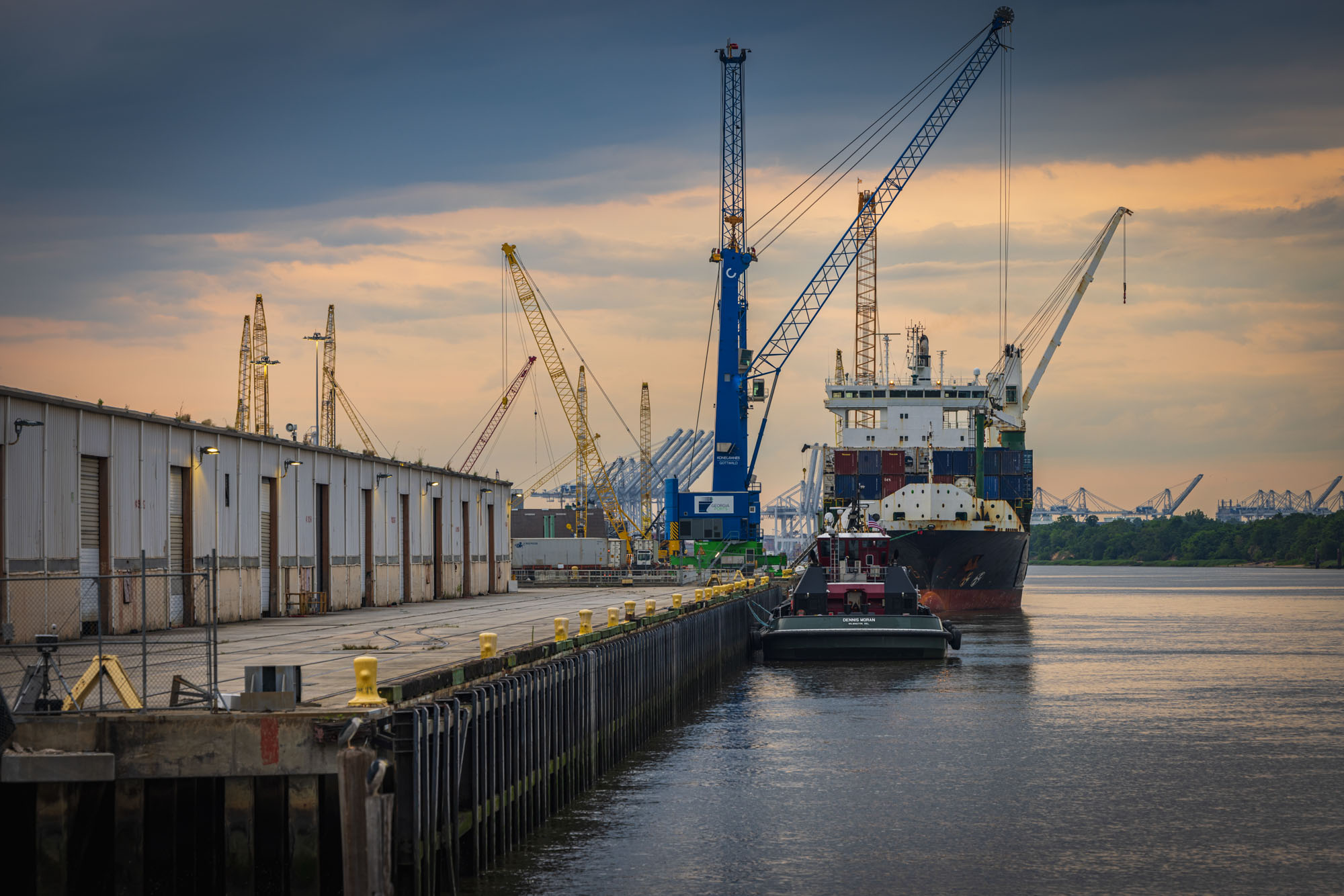 A barge is loaded at a dock. A barge is loaded at a dock.
