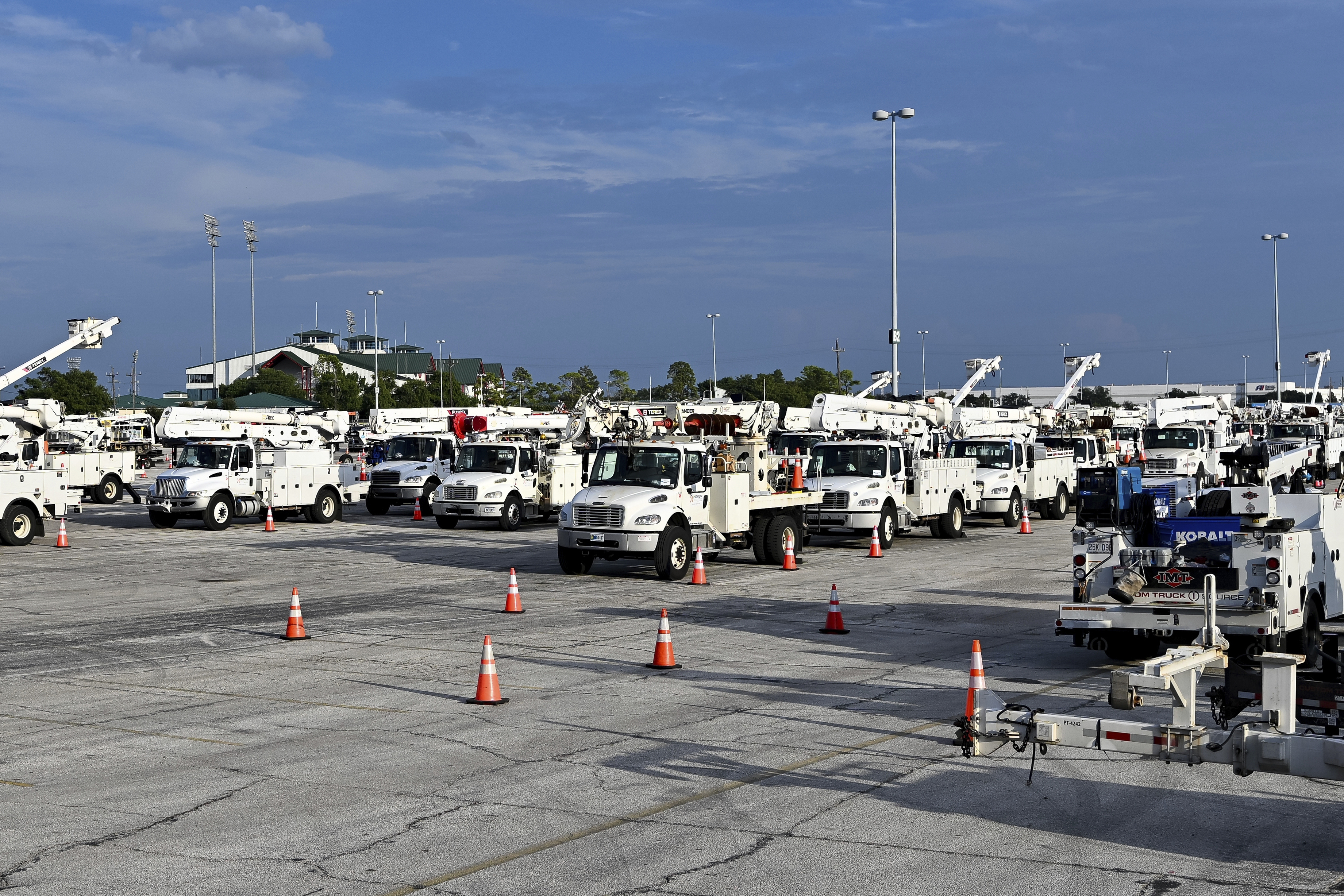 Utility trucks sit parked. Utility trucks sit parked.